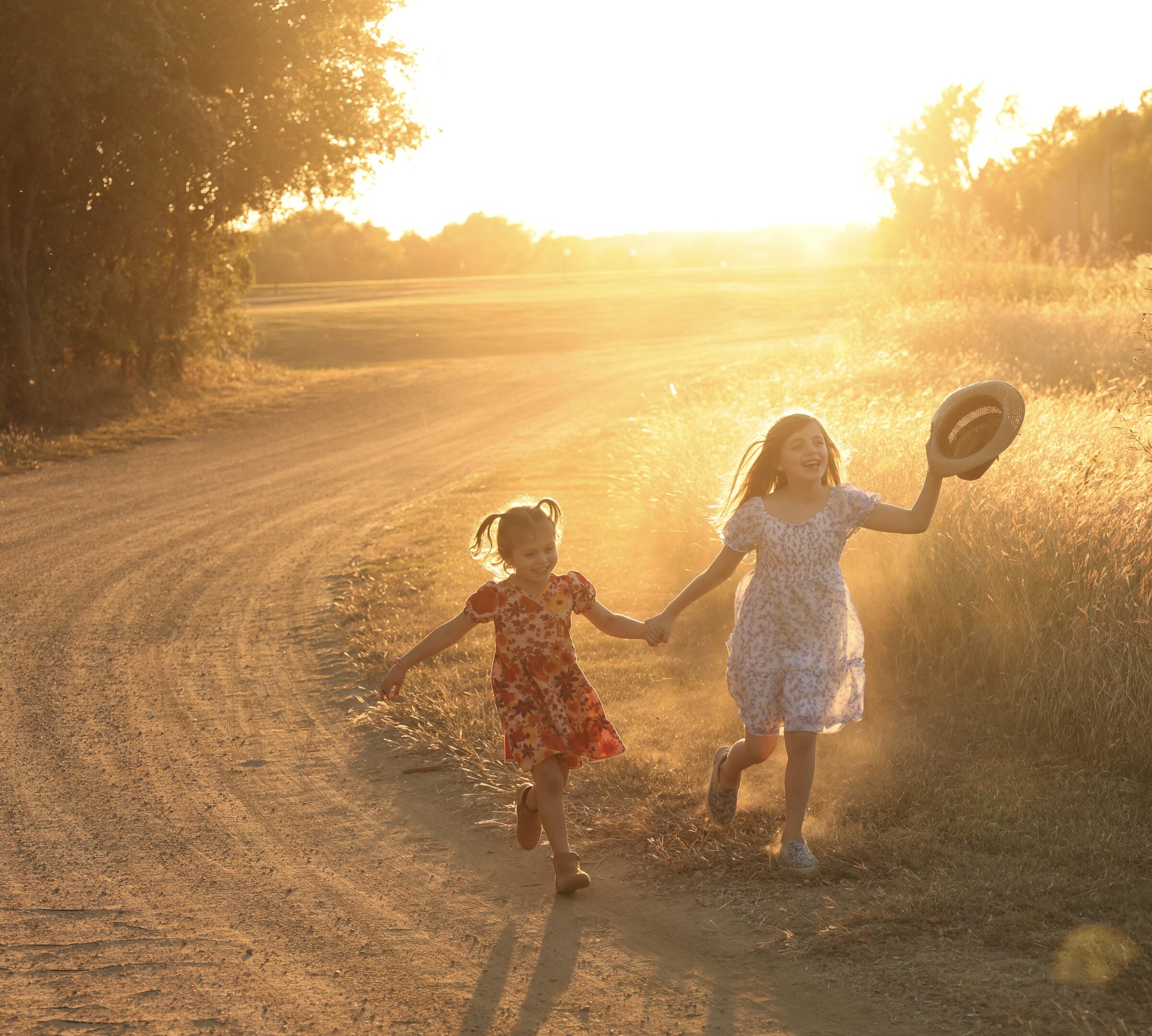 Sisters running at golden hour